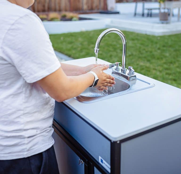 handwashing in a Monsam portable sink