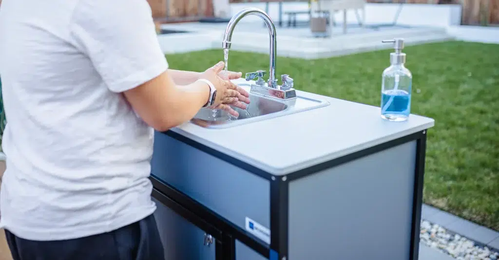 Handwashing in a Monsam portable sink