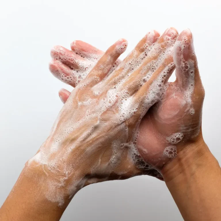 Two hands with soap, one holding the other, symbolizing the importance of handwashing for health on Global Handwashing Day.